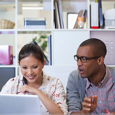 Two People Working on Laptop